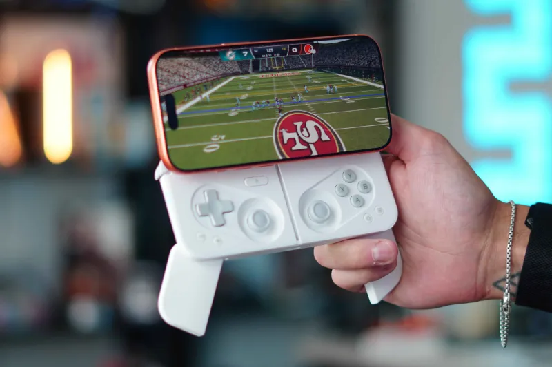 Smartphone displaying a fictional mobile game at an Australian gaming technology exhibition
